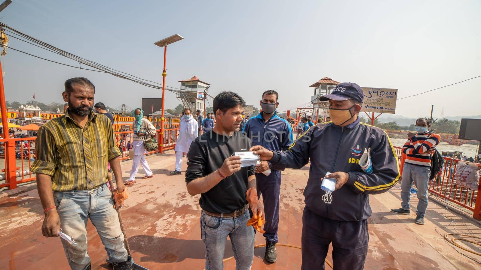 Policemen spreading awareness of protection from Coronavirus to stay safe from Coronavirus during Maha Kumbh 2021 by stocksvids