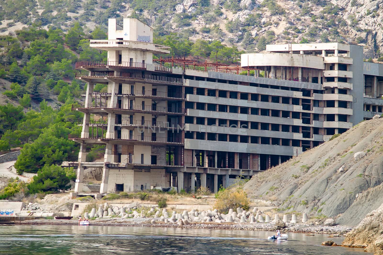 Abandoned hotel. View from the sea. Sunny autumn day. Side view. by Essffes