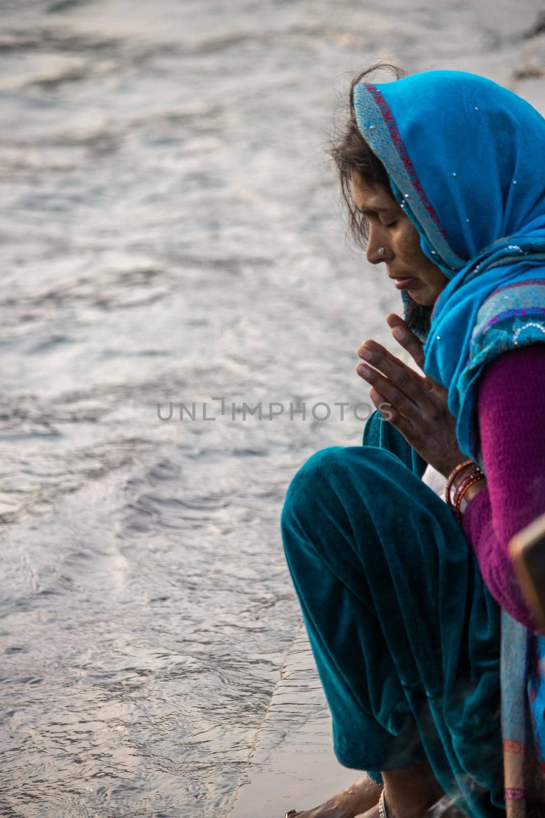 Indian woman worship Holy river Ganges by stocksvids