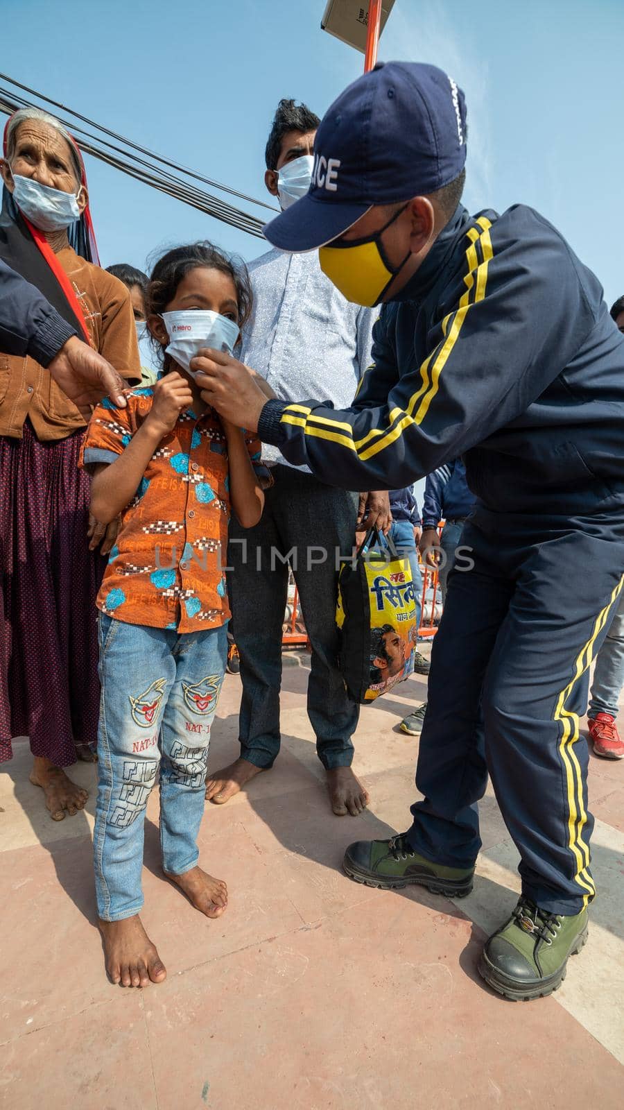 Haridwar, Uttarakhand India April 06, 2021. Policemen wearing protection mask to a child to stay safe from Coronavirus during Maha Kumbh 2021. Apple prores 422 High-quality 4k footage.