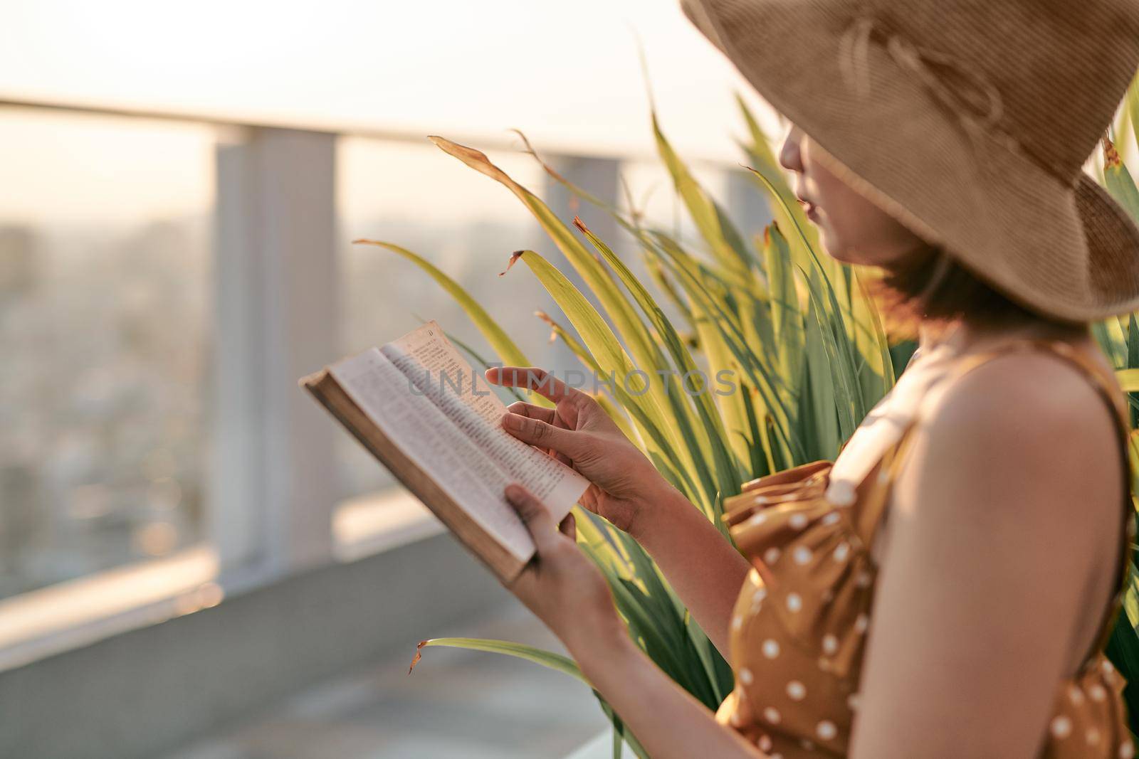 Portrait of young Asian girl is reading book in roof top of building.