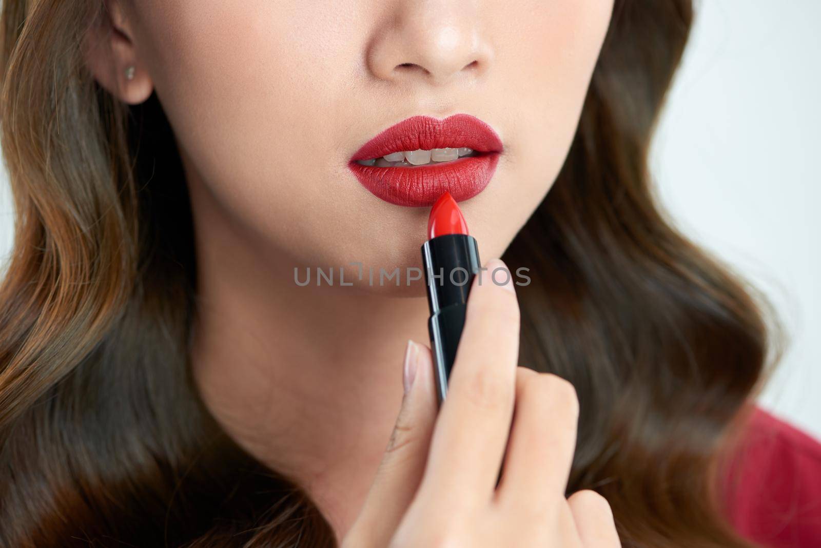 close up of beauty skincare woman take lipstick on the white background by makidotvn