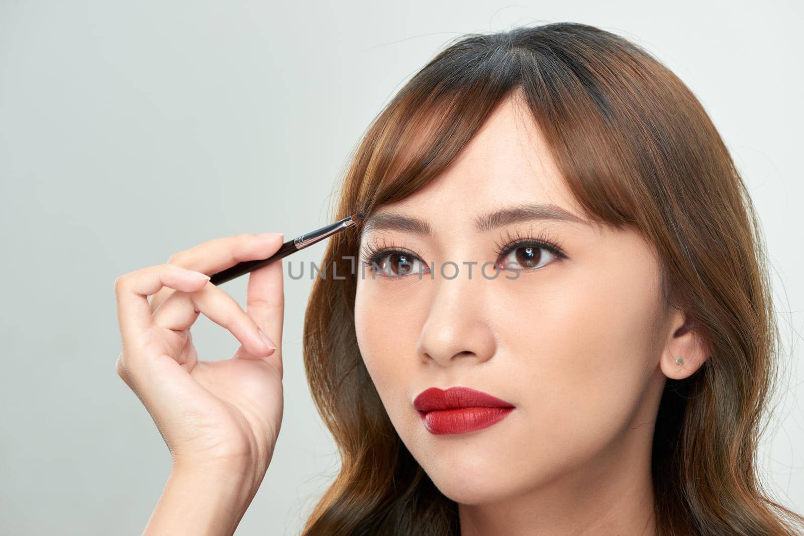 Asian young beautiful woman applying cosmetic powder brush on eyebrow, natural makeup, beauty face by makidotvn