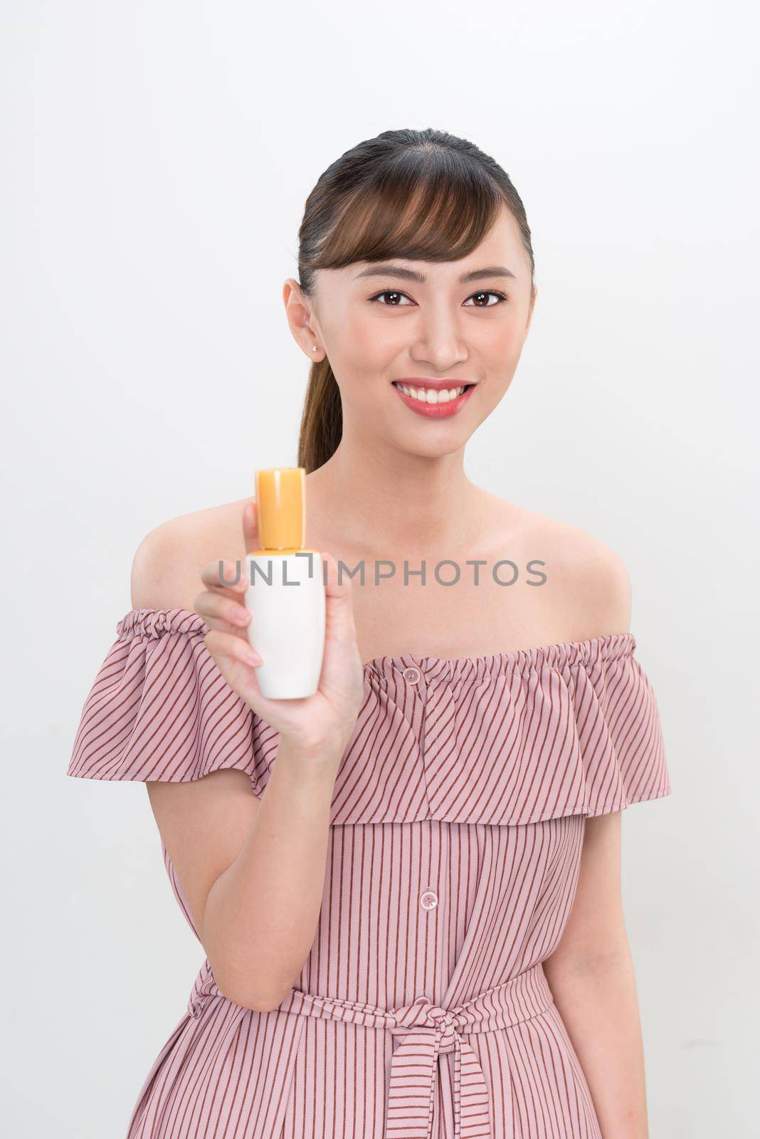 asian woman showing cream on her hand, isolated on white by makidotvn