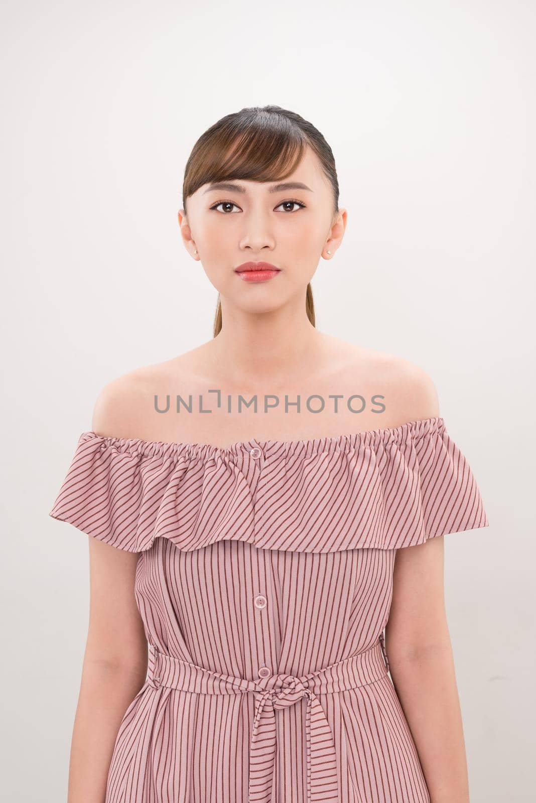 beautiful young asian woman posing on white background with copy space 