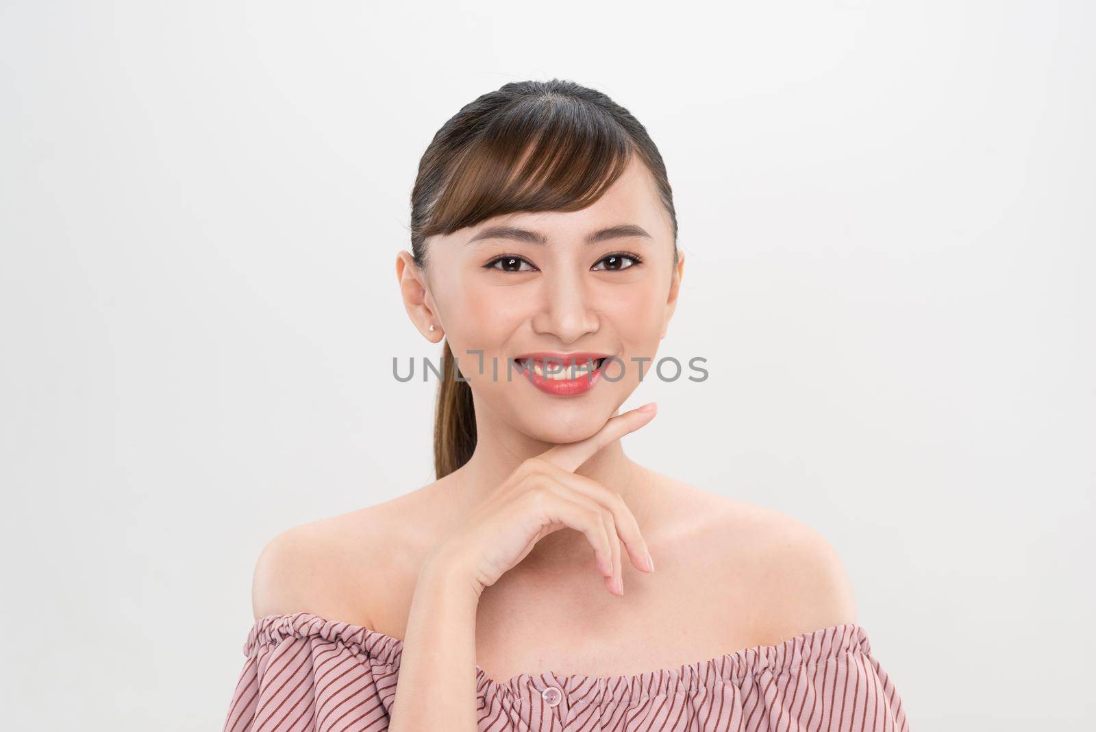 closeup young smiling woman face isolated on white
