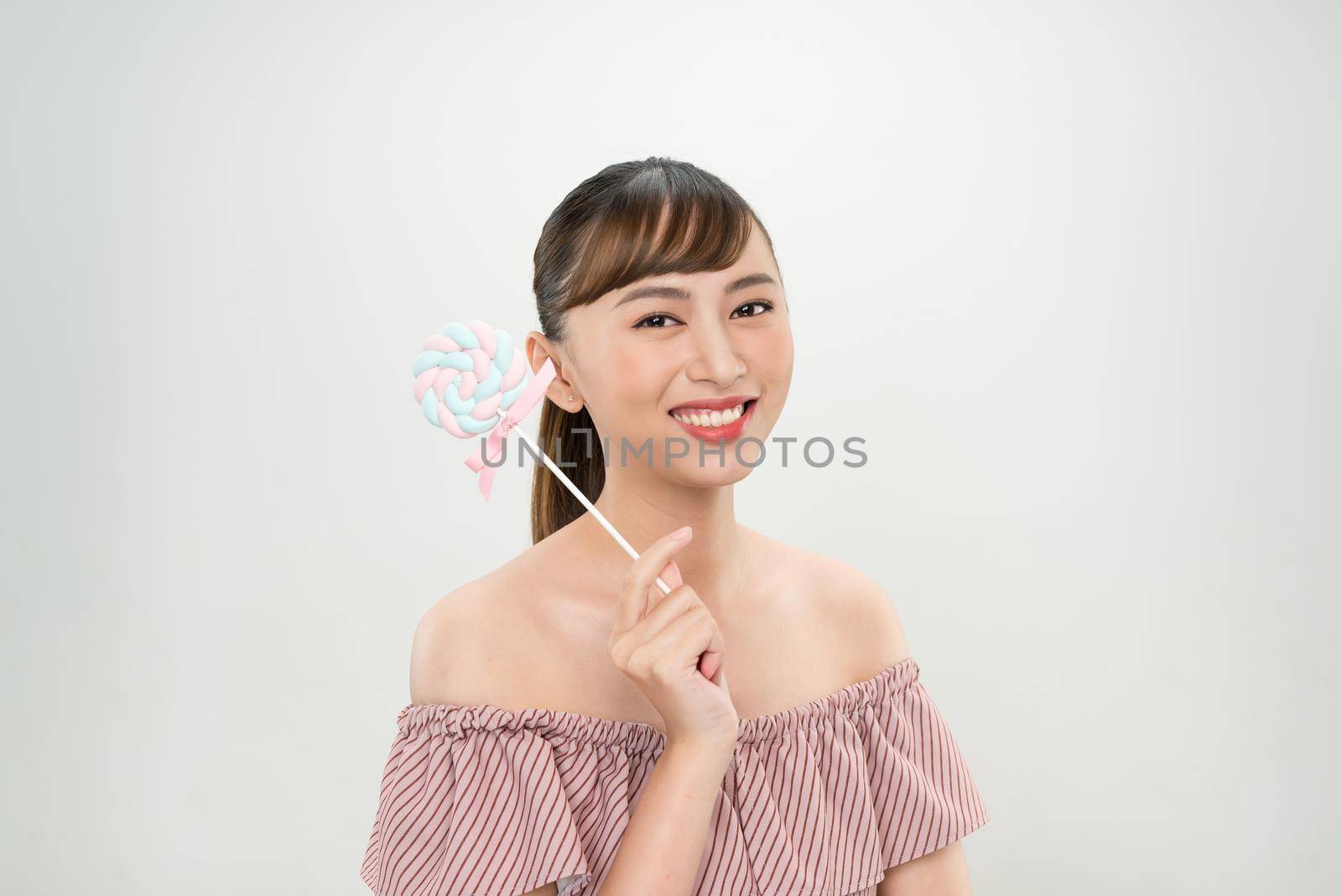 young asian woman with lolipop 