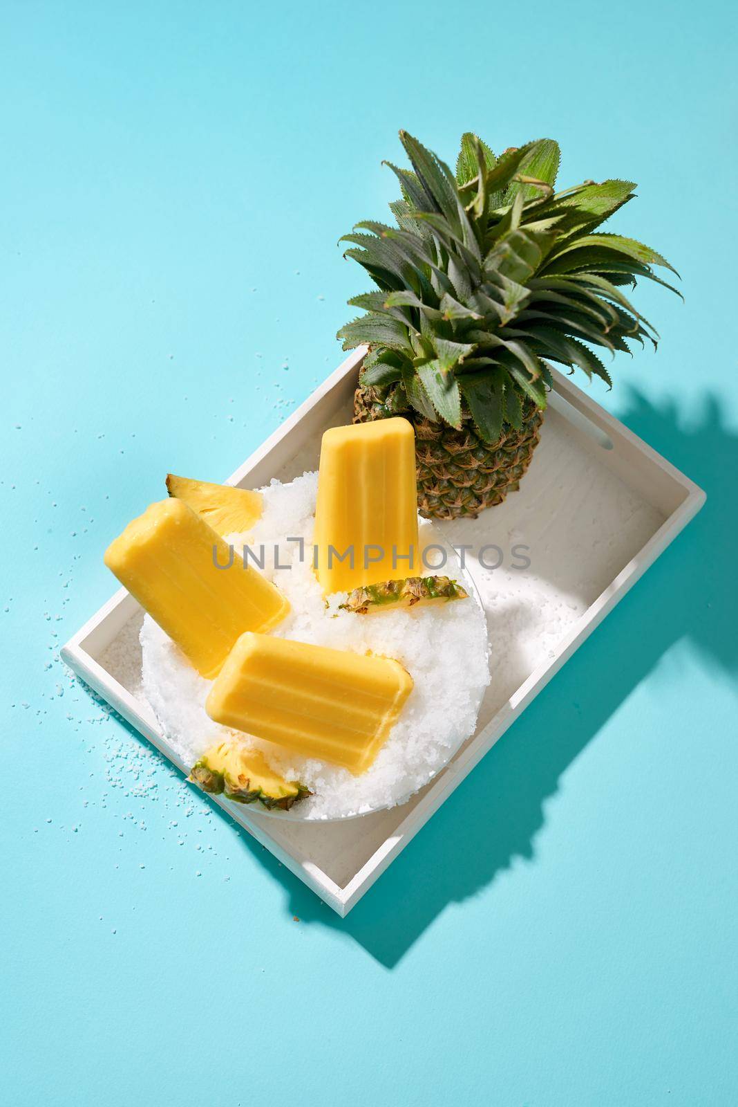 Fruit pineapple ice cream on a stick. Bright color, summer mood