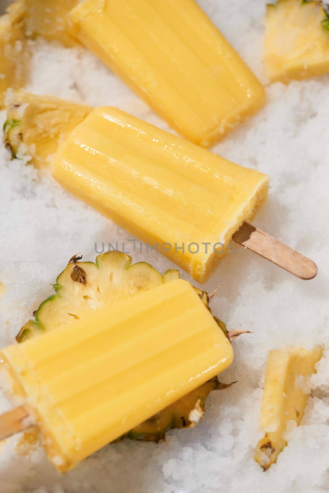Homemade popsicles with pineapple on stick, top view