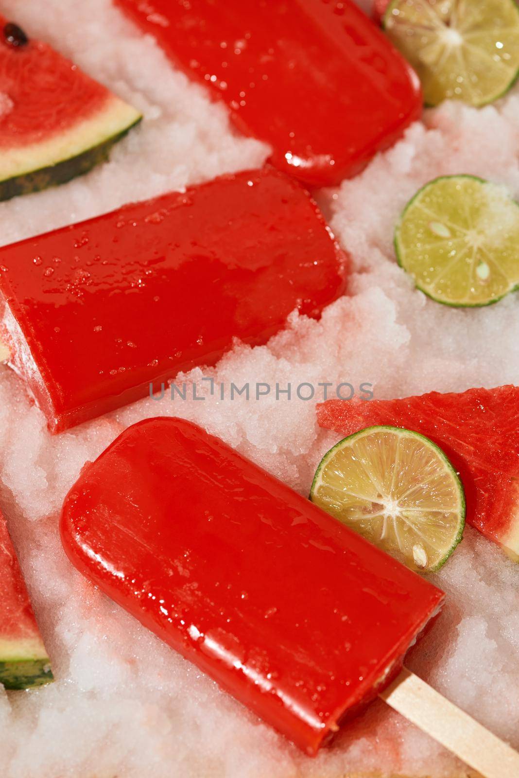 Watermelon popsicle and sliced lemon on ice tray