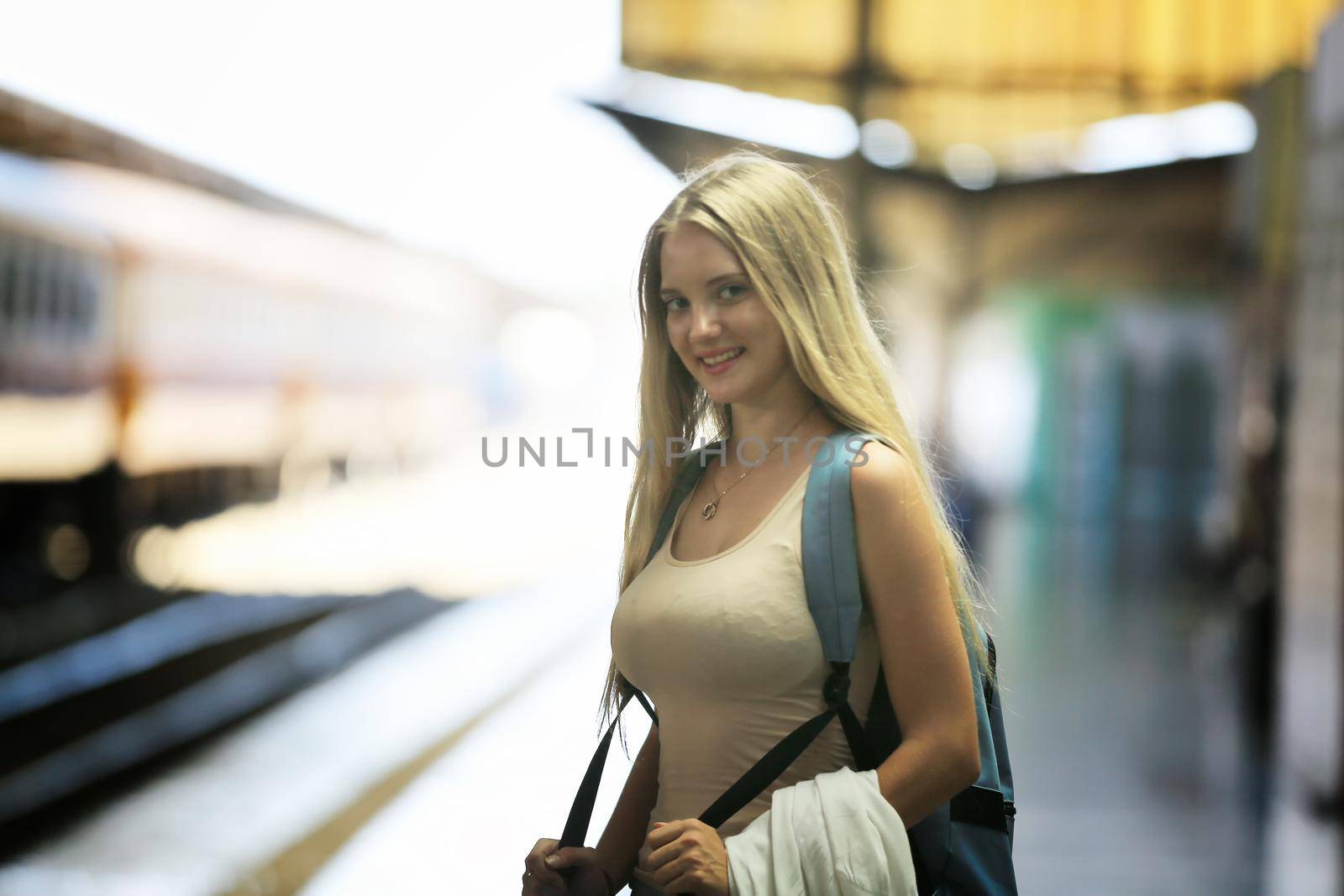 young woman waiting in vintage train, relaxed and carefree at the station platform in Bangkok, Thailand before catching a train. Travel photography. Lifestyle. by chuanchai