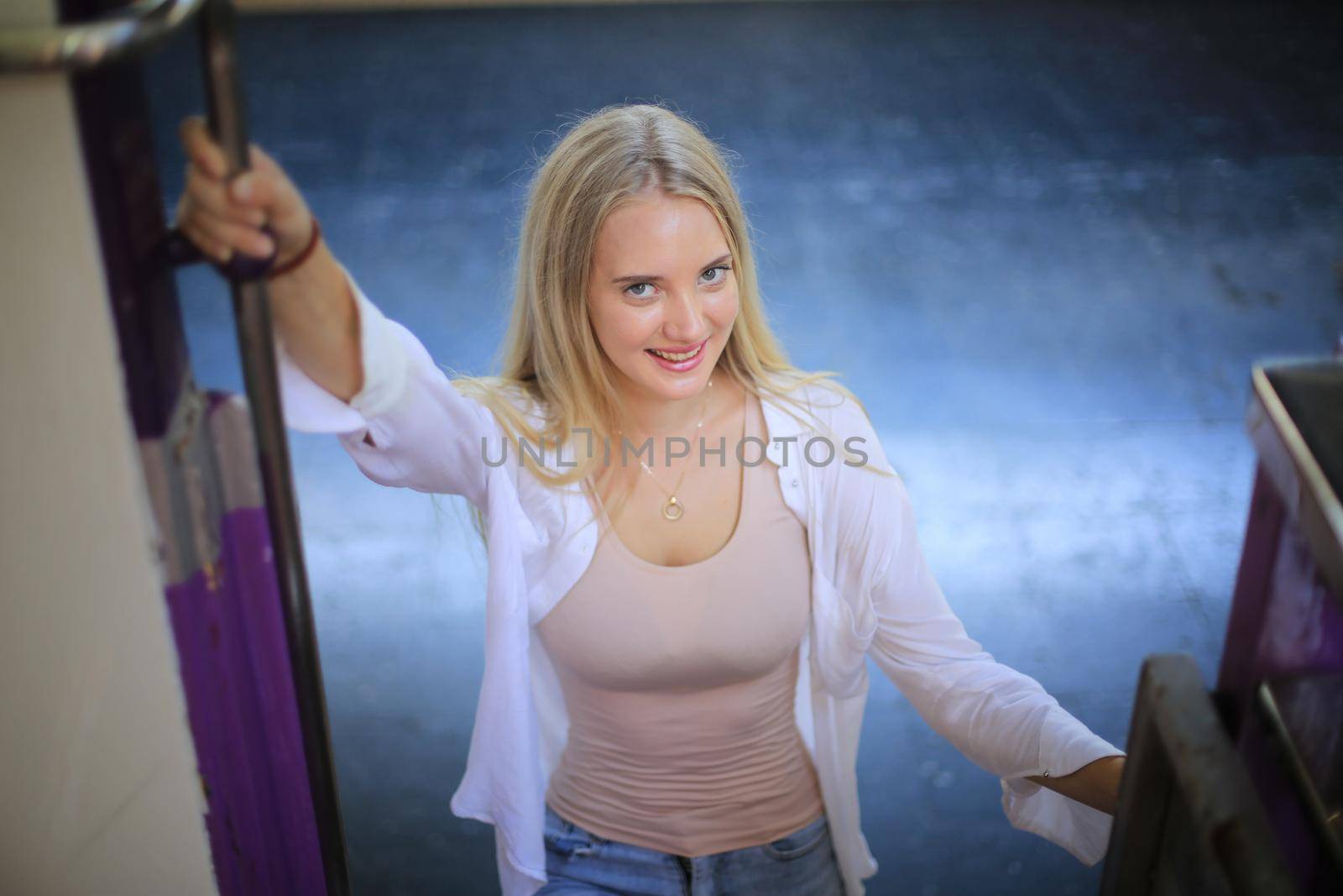 young woman waiting in vintage train, relaxed and carefree at the station platform in Bangkok, Thailand before catching a train. Travel photography. Lifestyle.