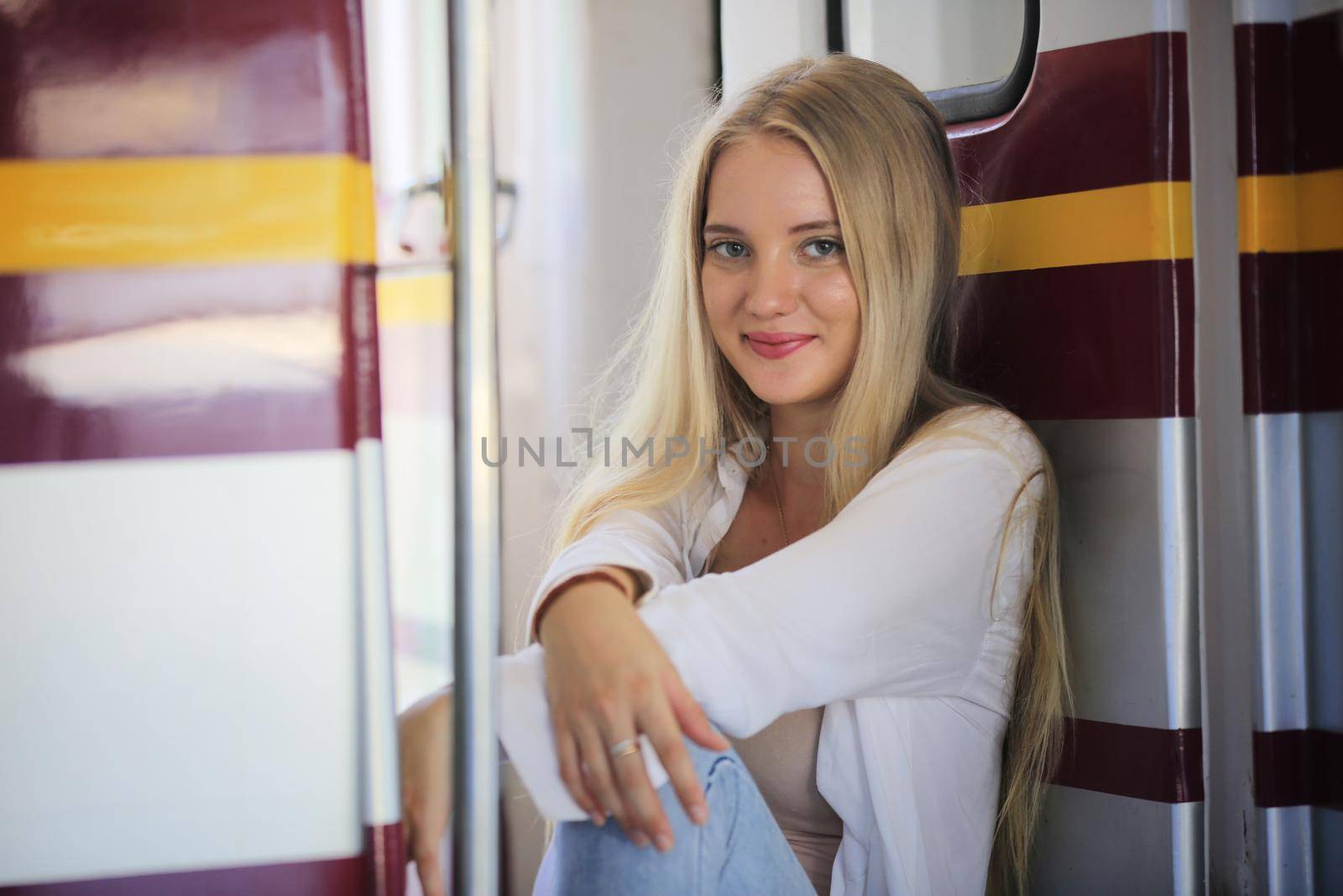 young woman waiting in vintage train, relaxed and carefree at the station platform in Bangkok, Thailand before catching a train. Travel photography. Lifestyle. by chuanchai