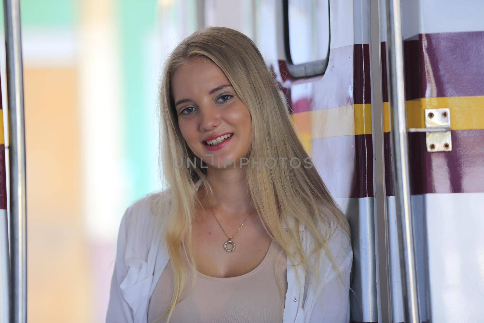 young woman waiting in vintage train, relaxed and carefree at the station platform in Bangkok, Thailand before catching a train. Travel photography. Lifestyle. by chuanchai