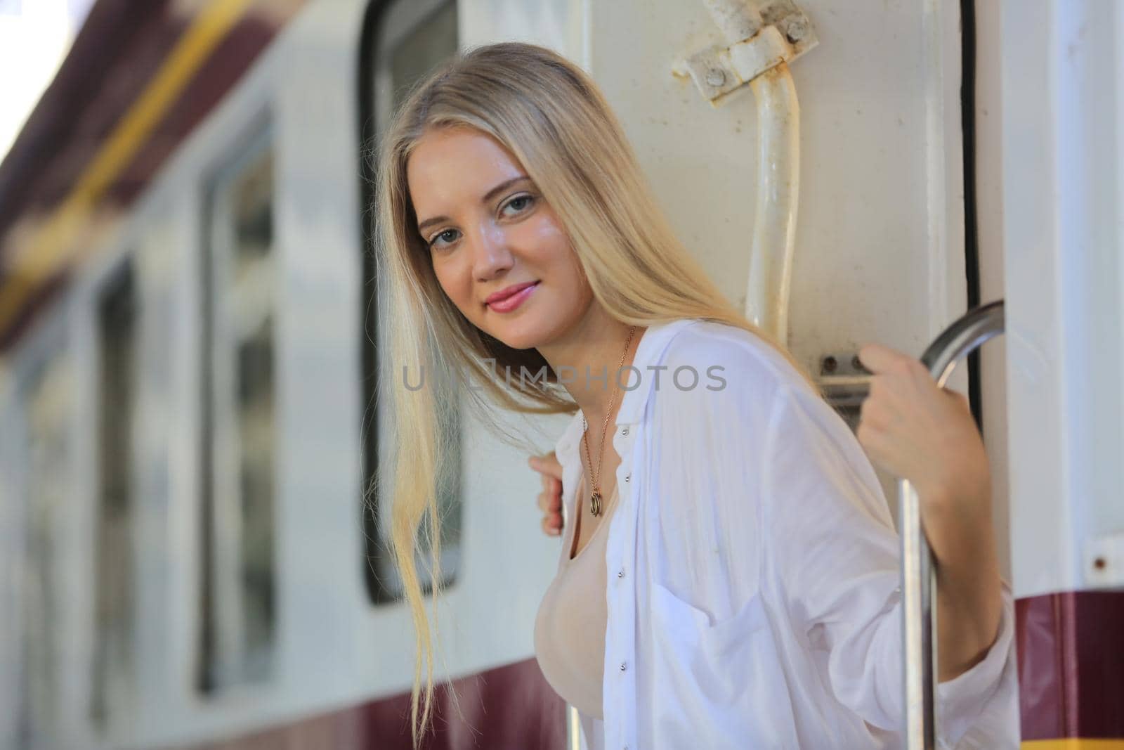 young woman waiting in vintage train, relaxed and carefree at the station platform in Bangkok, Thailand before catching a train. Travel photography. Lifestyle. by chuanchai