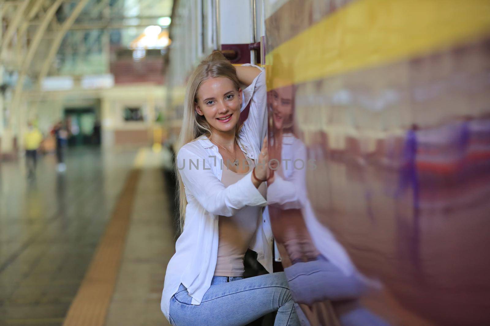 young woman waiting in vintage train, relaxed and carefree at the station platform in Bangkok, Thailand before catching a train. Travel photography. Lifestyle. by chuanchai