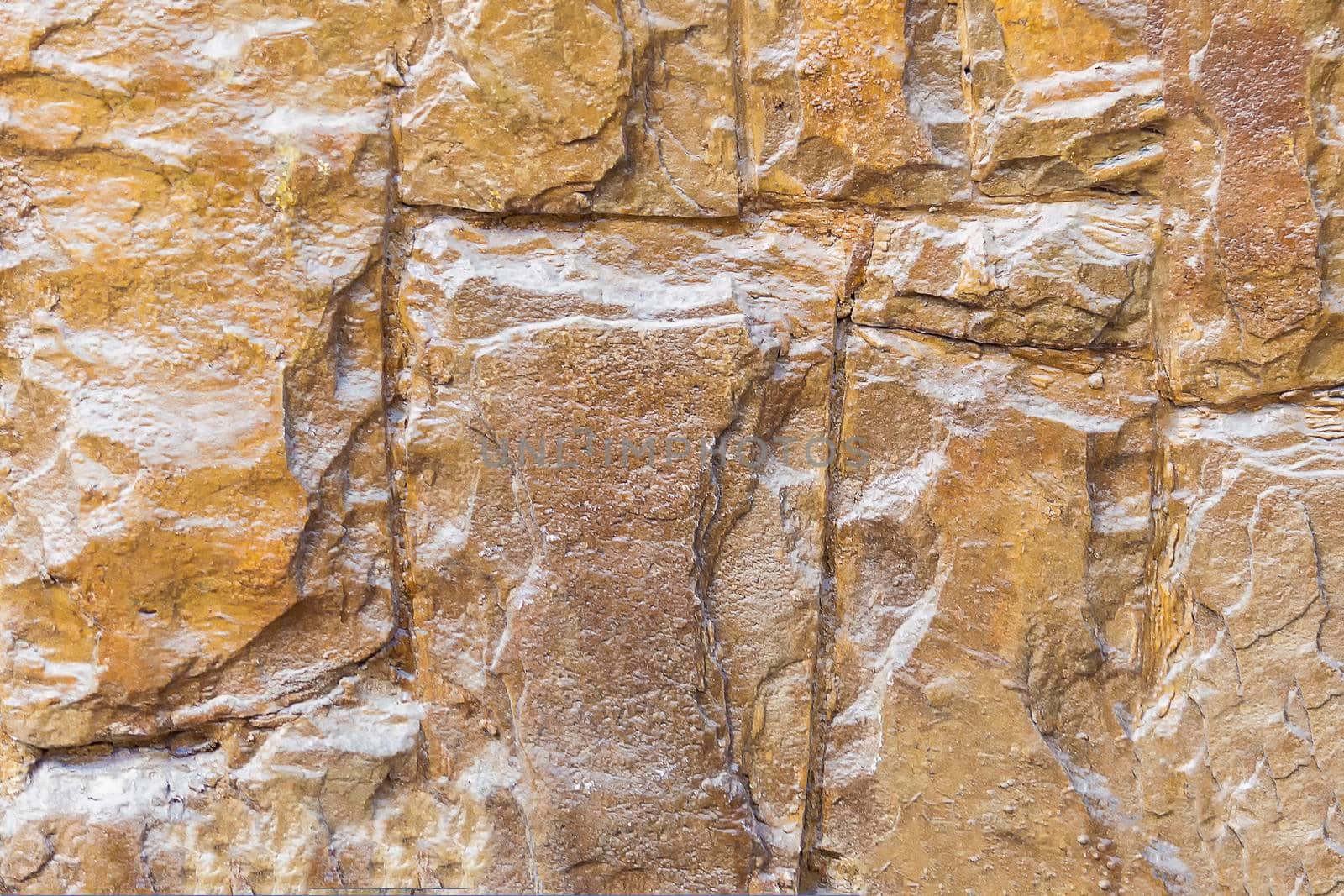 Stone background wall of yellow crimean limestone covered by Essffes