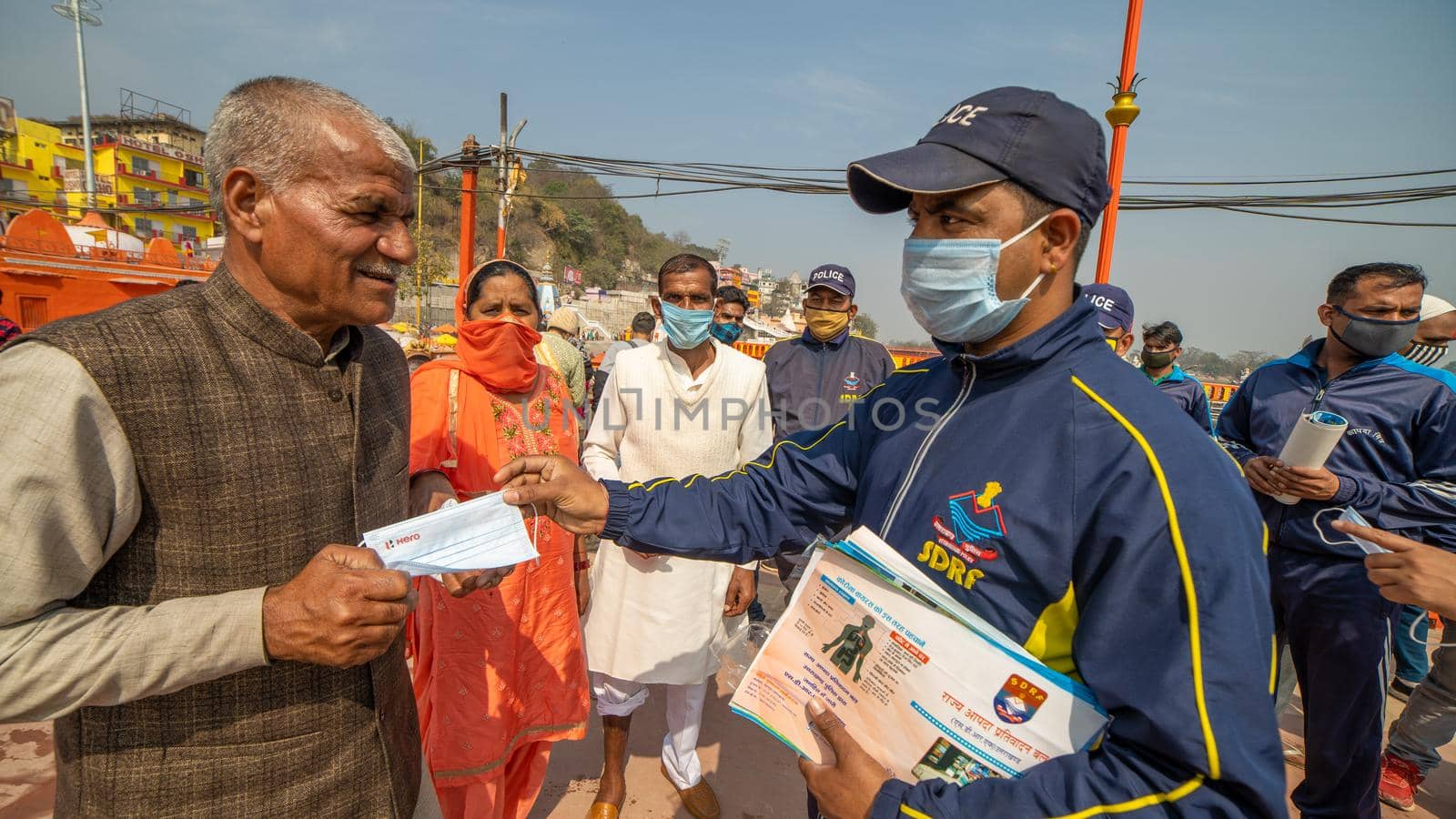 Policemen spreading awareness of protection from Coronavirus to stay safe from Coronavirus during Maha Kumbh 2021 by stocksvids