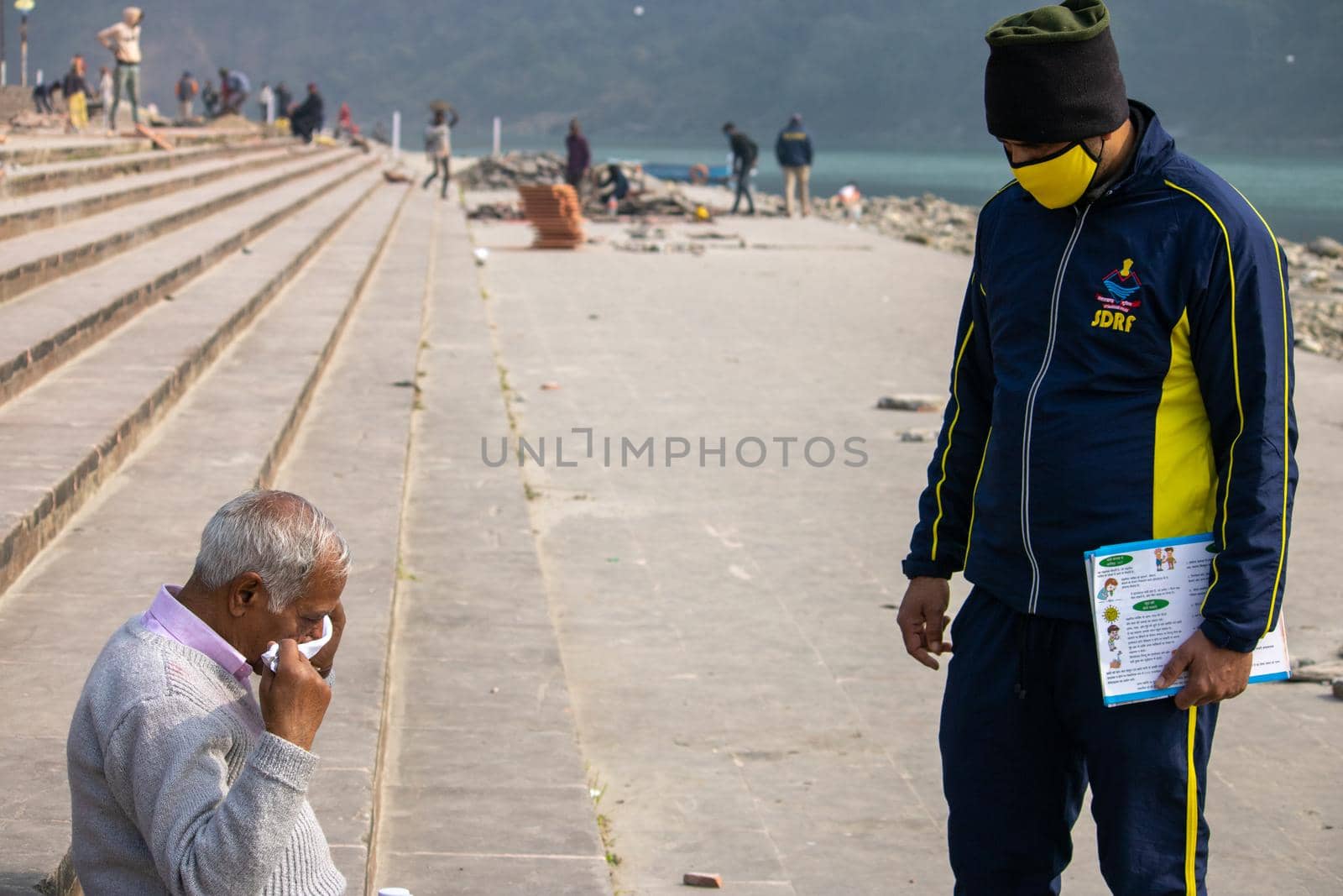 Policemen spreading awareness of protection from Coronavirus to stay safe from Coronavirus during Maha Kumbh 2021 by stocksvids