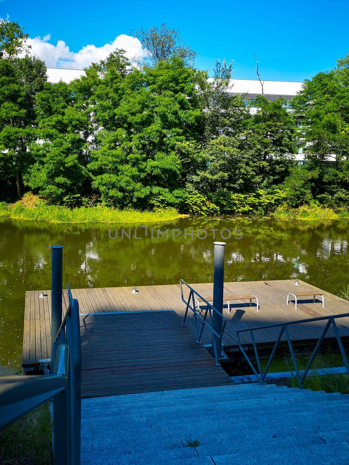 Wooden platform with benches as relaxing area on river