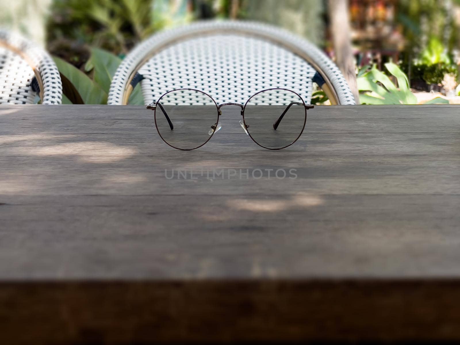 Eyeglasses on old wooden table, stock photo