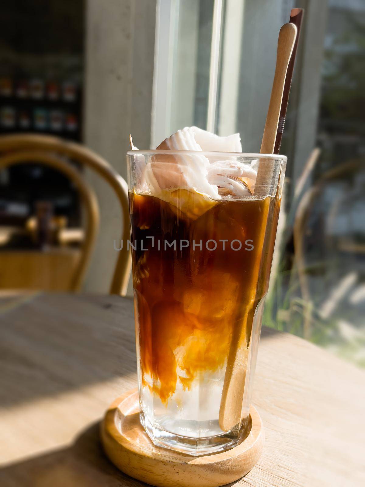 A glass of iced americano with coconut juice by punsayaporn