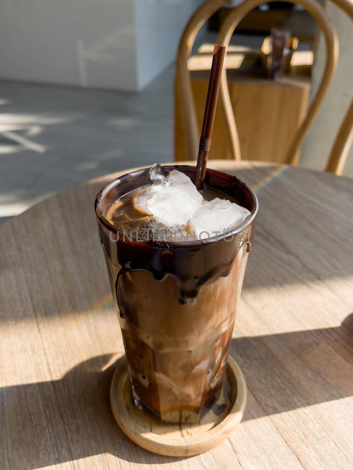 Iced mocha on wooden table by punsayaporn