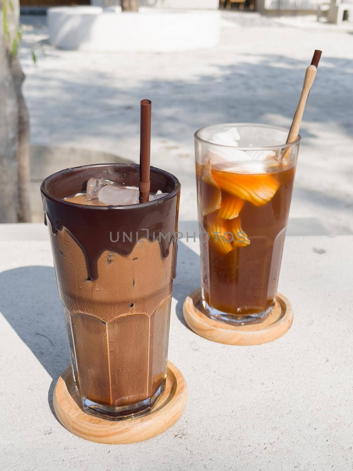 A glass of iced mocha and iced americano with coconut juice by punsayaporn