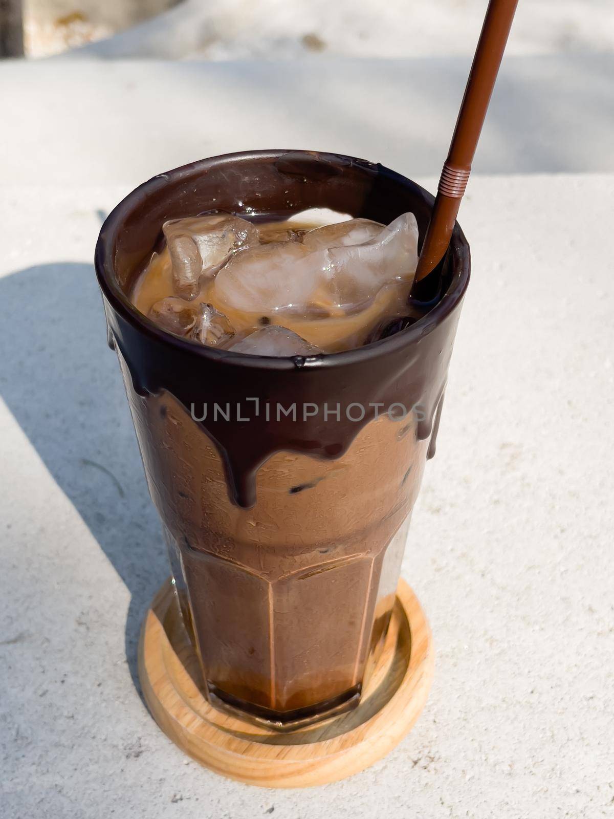 Iced mocha on concrete table by punsayaporn