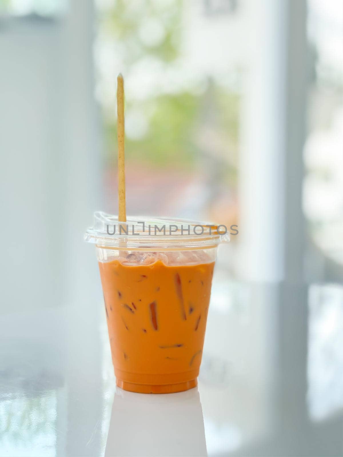 A glass of iced Thai milk tea by punsayaporn