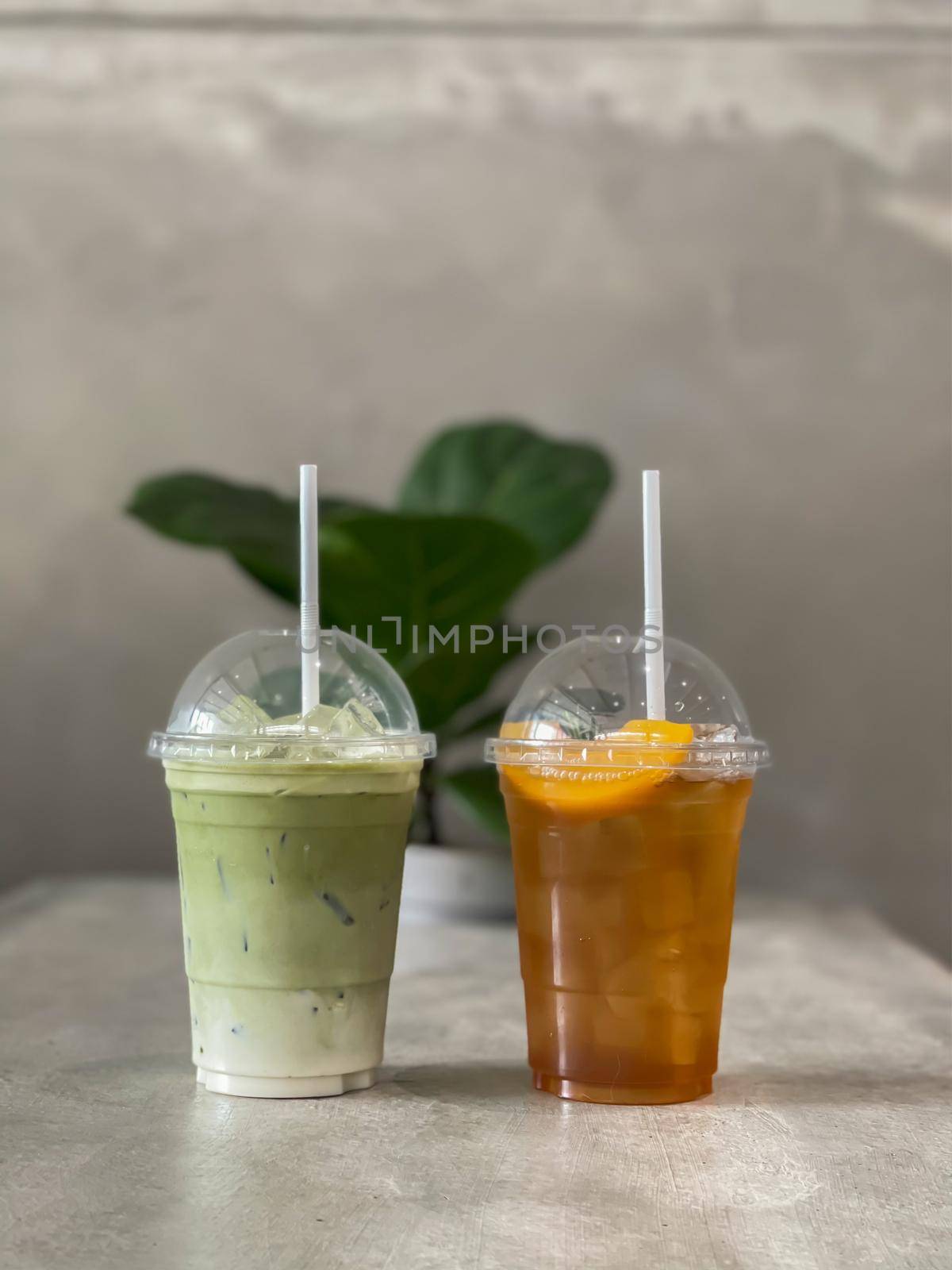 A glass of iced green tea and lemon tea by punsayaporn