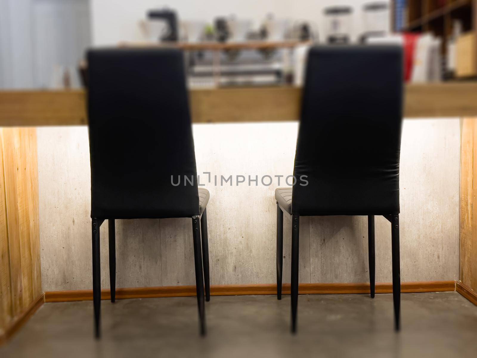 Black chairs decorated in coffee shop by punsayaporn