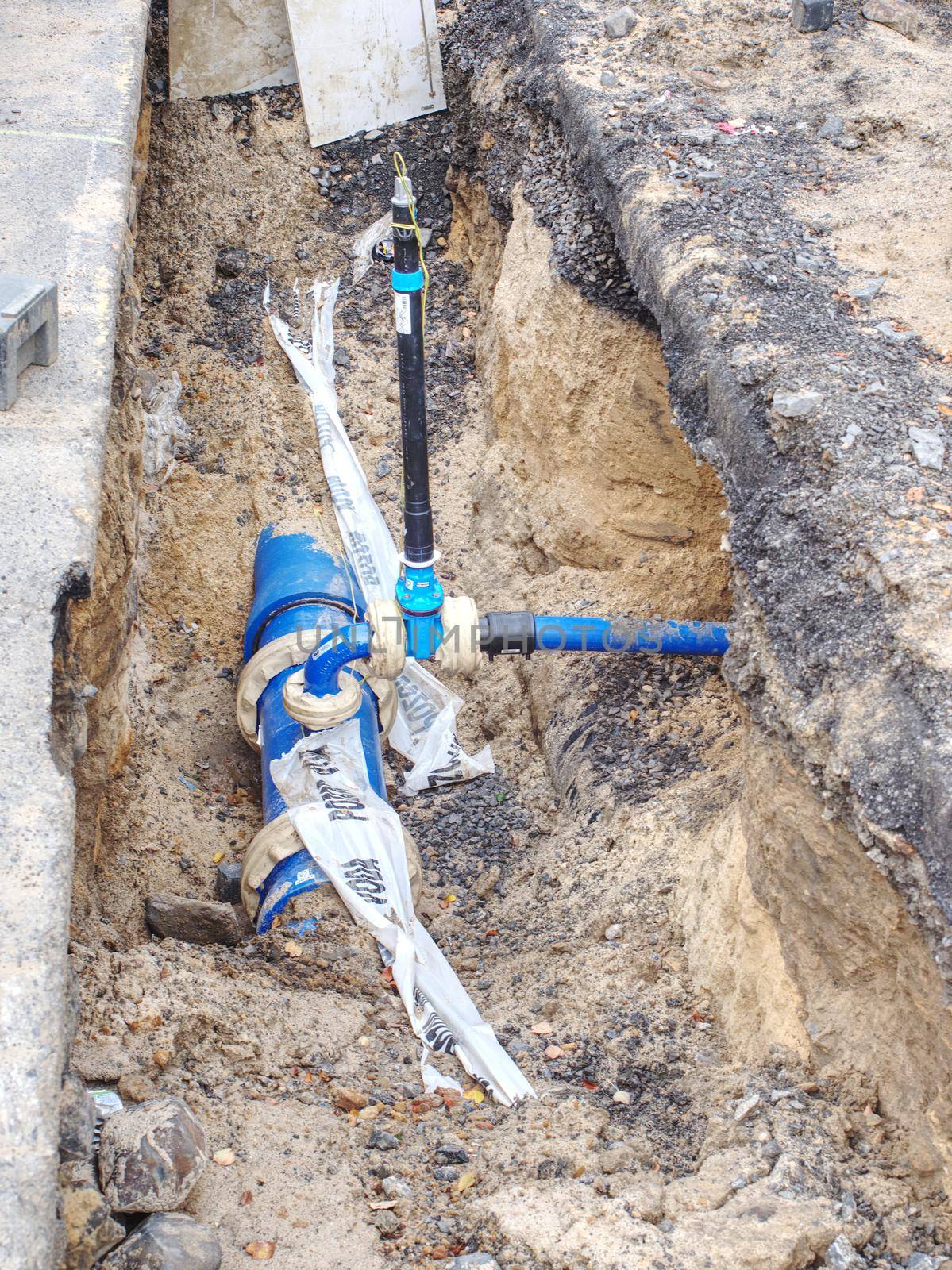 Plastic and steel pipes and valves underground. Repairing of main branch of town water delivery system