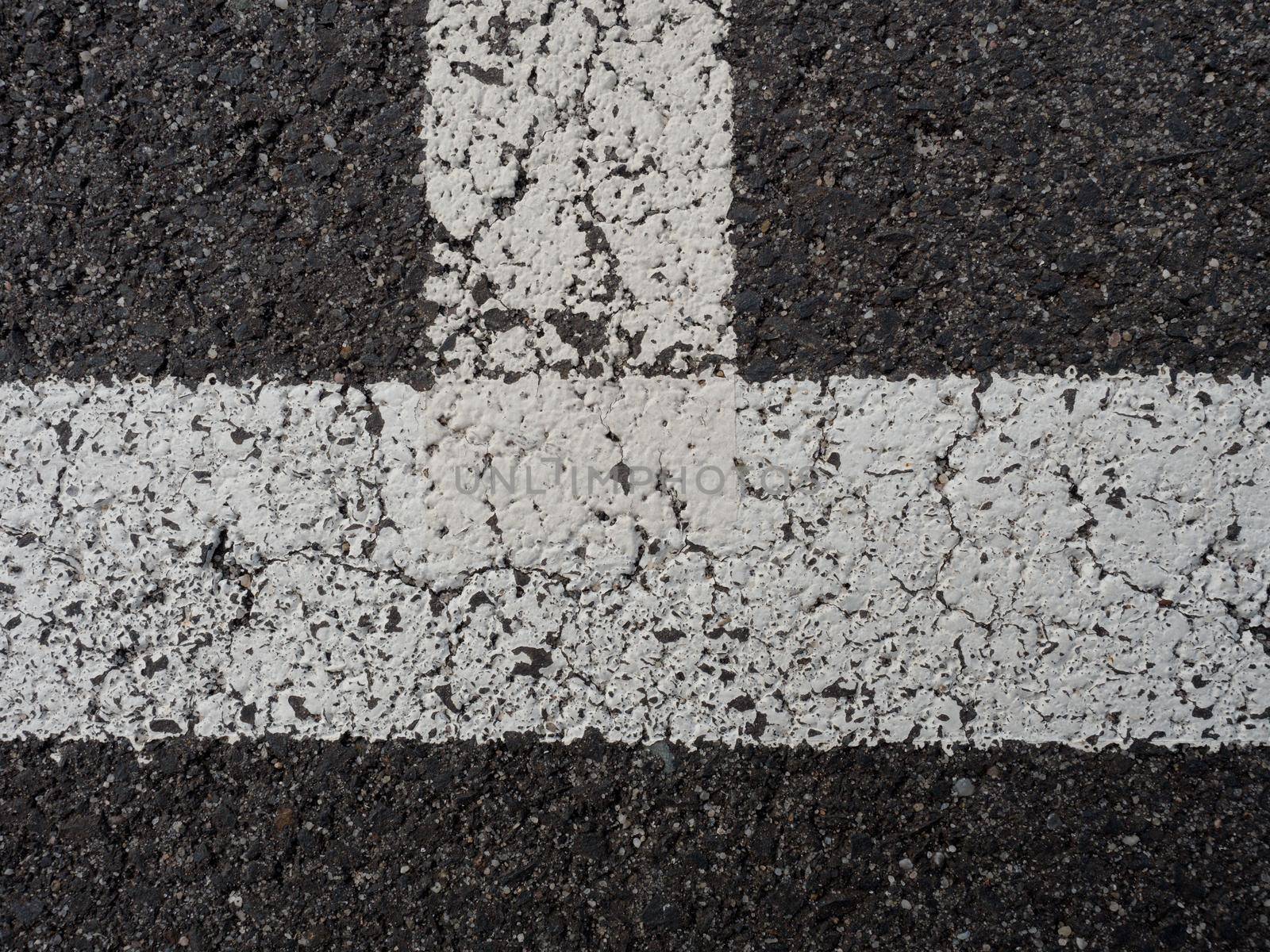 White paint line on old obsolete asphalt plaground. Empty kids areal.
