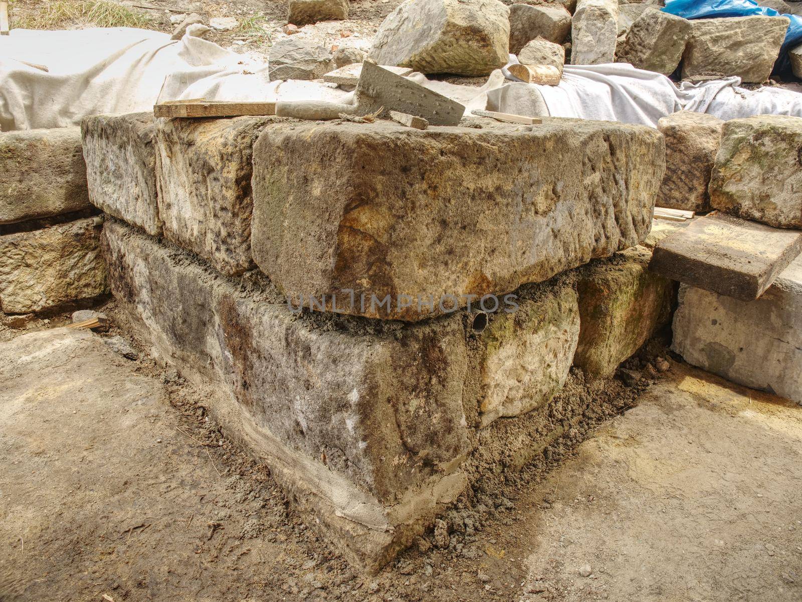 Natural stone wall, sandstone texture. Using of historical soft sand stones prepare for rebuilding of old house.