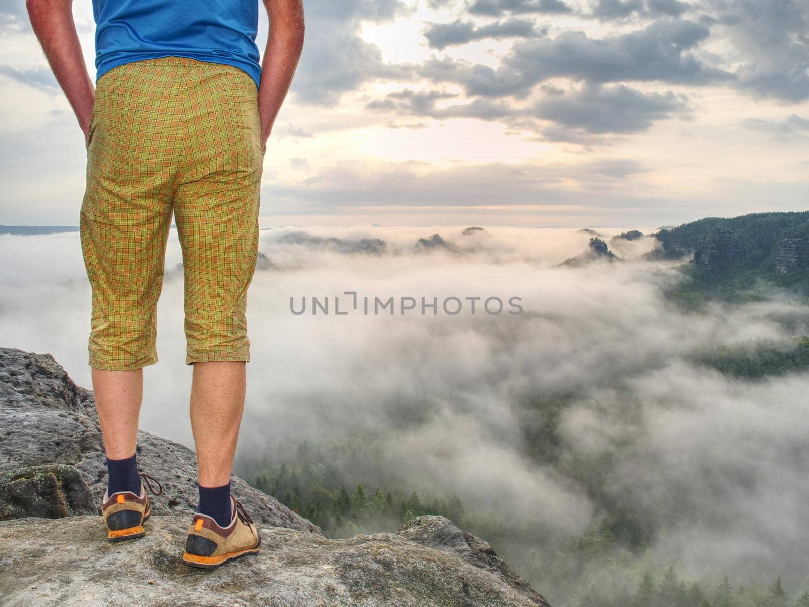 Nature misty show. Guy standing on top of the mountain. by rdonar2