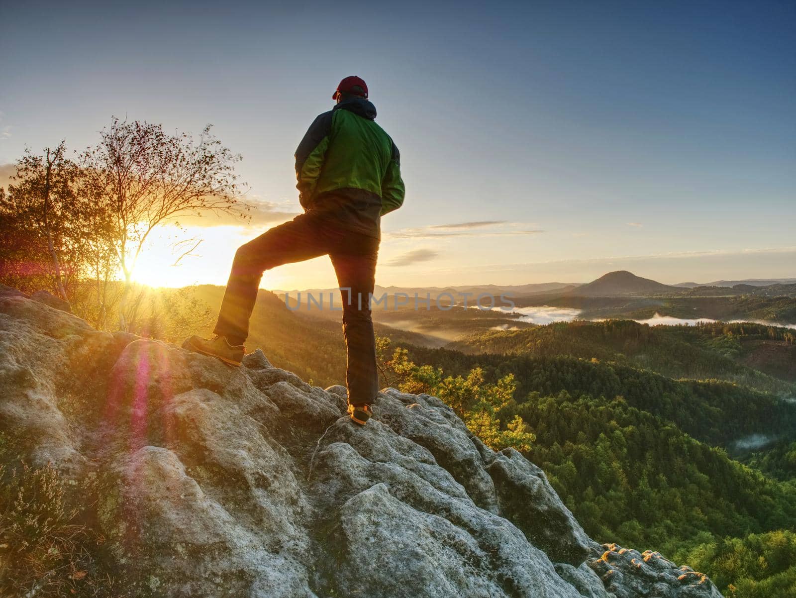 Man walking on the edge of a cliff at summit. Hrensko range by rdonar2