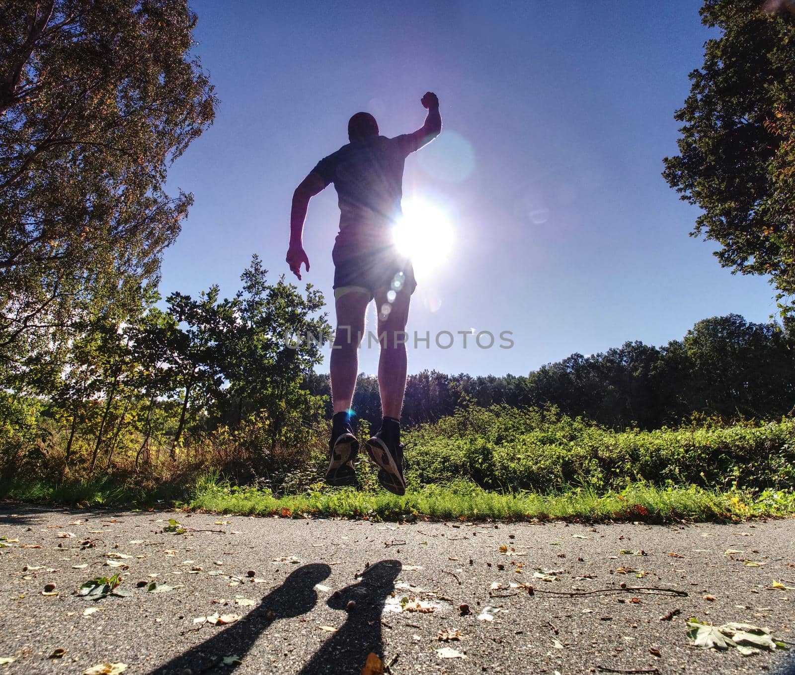 Man jogger run in park sunny day nature background. Man training, prepare his body for marathon