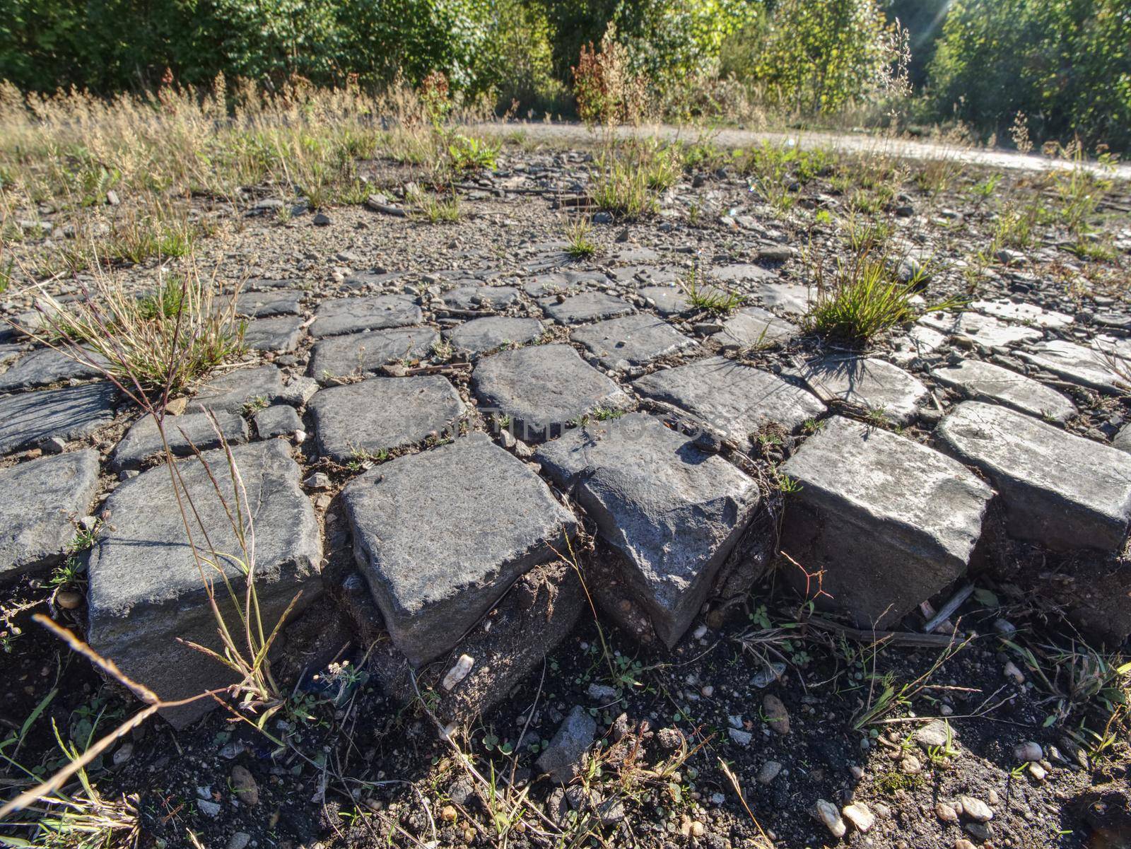 Ruined old cobble stone way. Paving Stones Road. Crawl destroyed urban sidewalk construction stones 