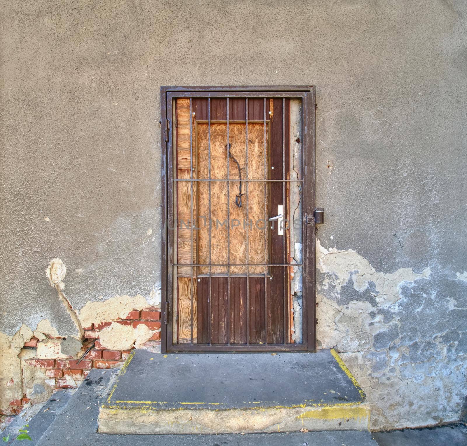 Bolted windows and a walled door on the facade of an abandoned building