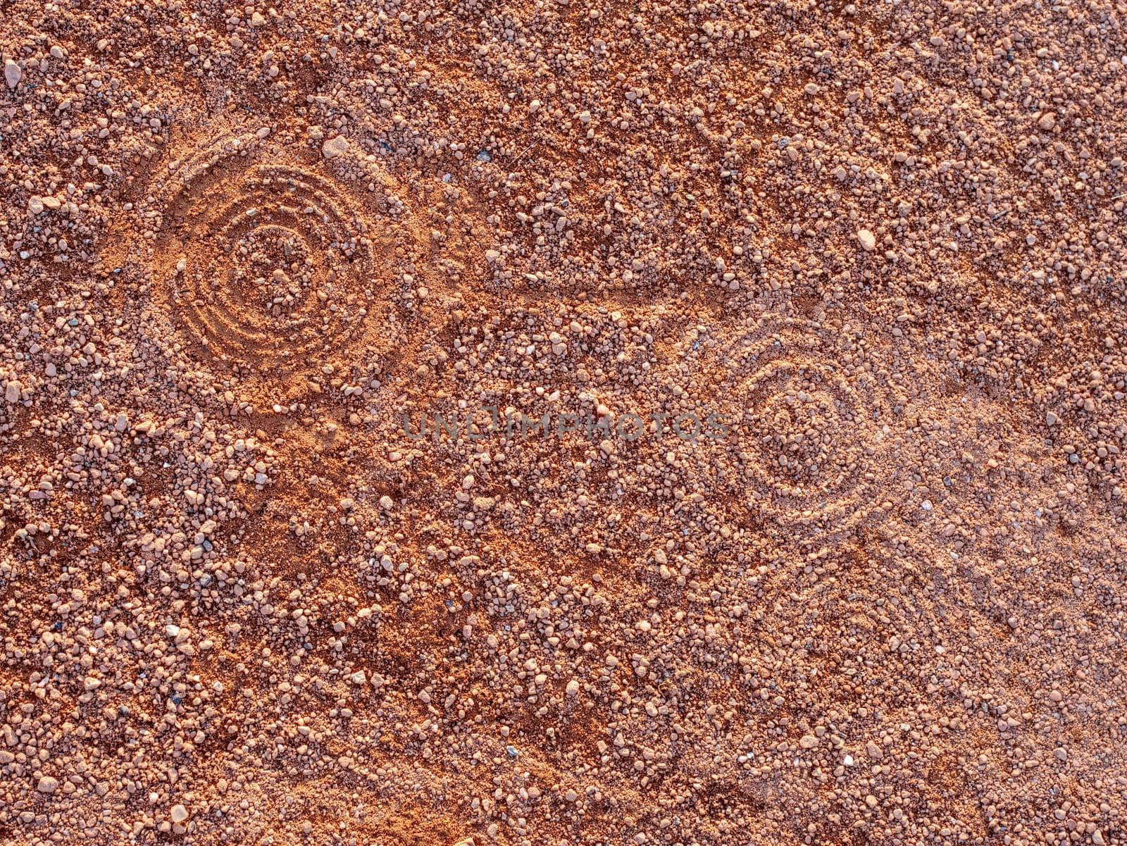 Sport shoe footprint on a tennis clay court. Dry light red crushed bricks surface on outdoor tennis ground