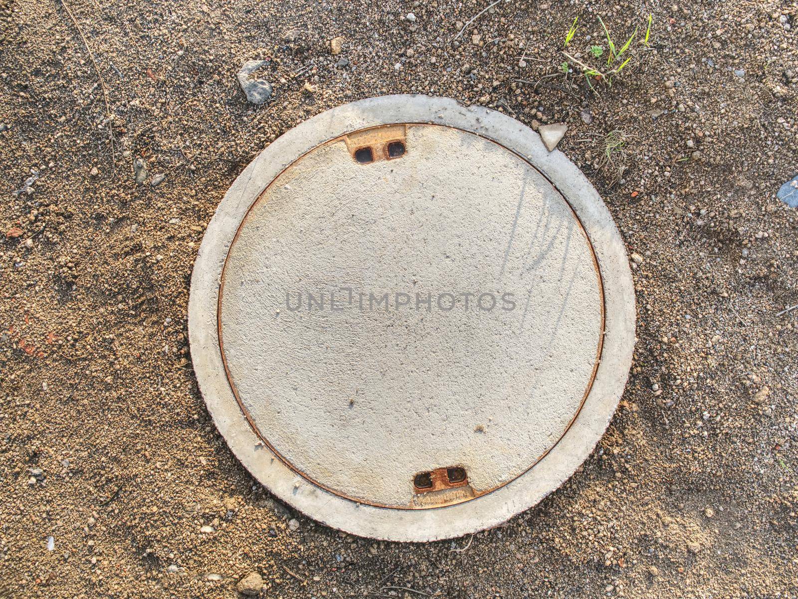 Manhole with the concrete cover on the concrete basement