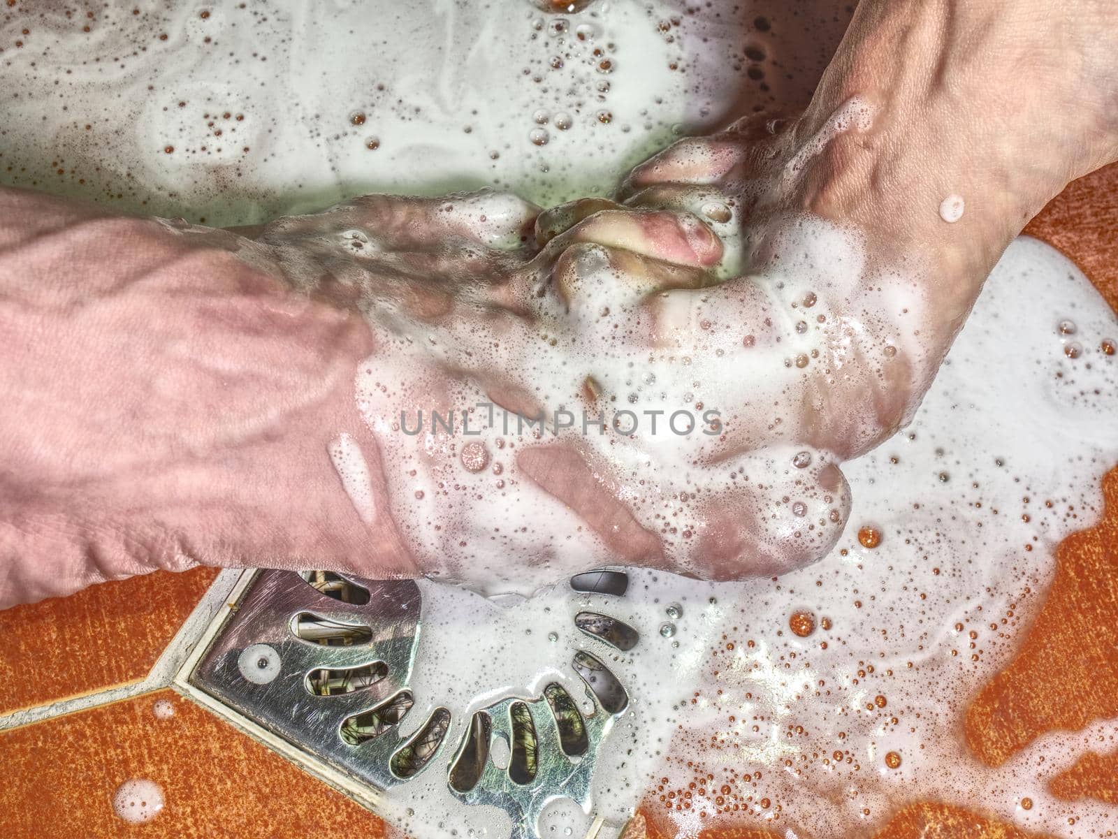 Adult pair of lovers stay together and splashes the water of the shower.