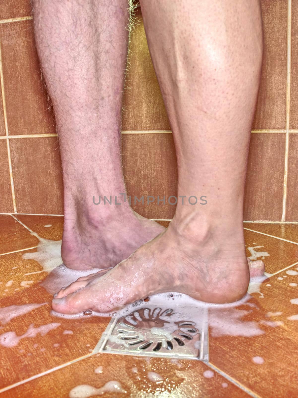 Feet of girlfriend and boyfriend in shower stall. by rdonar2