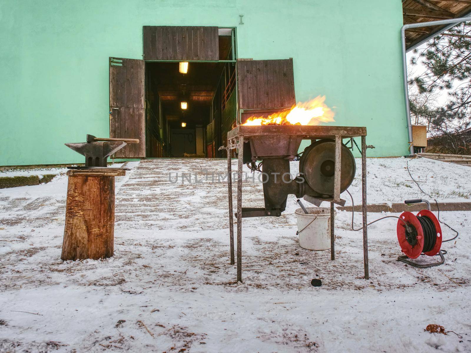 Blacksmith hot coals in a clay oven. Smith heating iron metal sword manufacturing marching forge