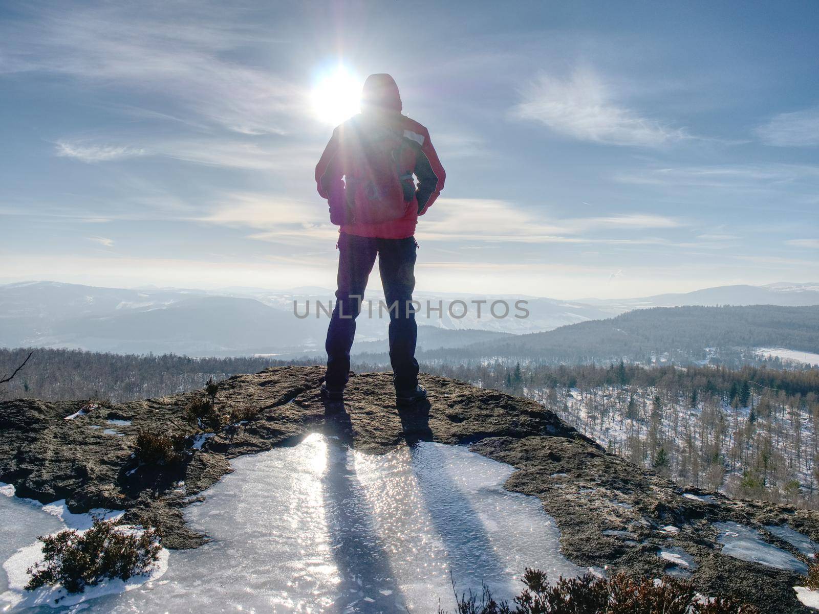 Hiker relaxing on top of hill and enjoying view by rdonar2