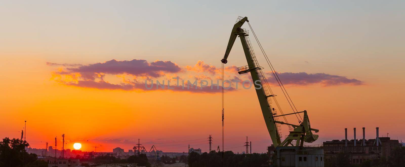  KIEV, UKRAINE - May 30, 2018: Industrial district of Kiev in Podil district. Dnieper and the river port. View from cable-stayed Rybalsky bridge in the evening during sunset