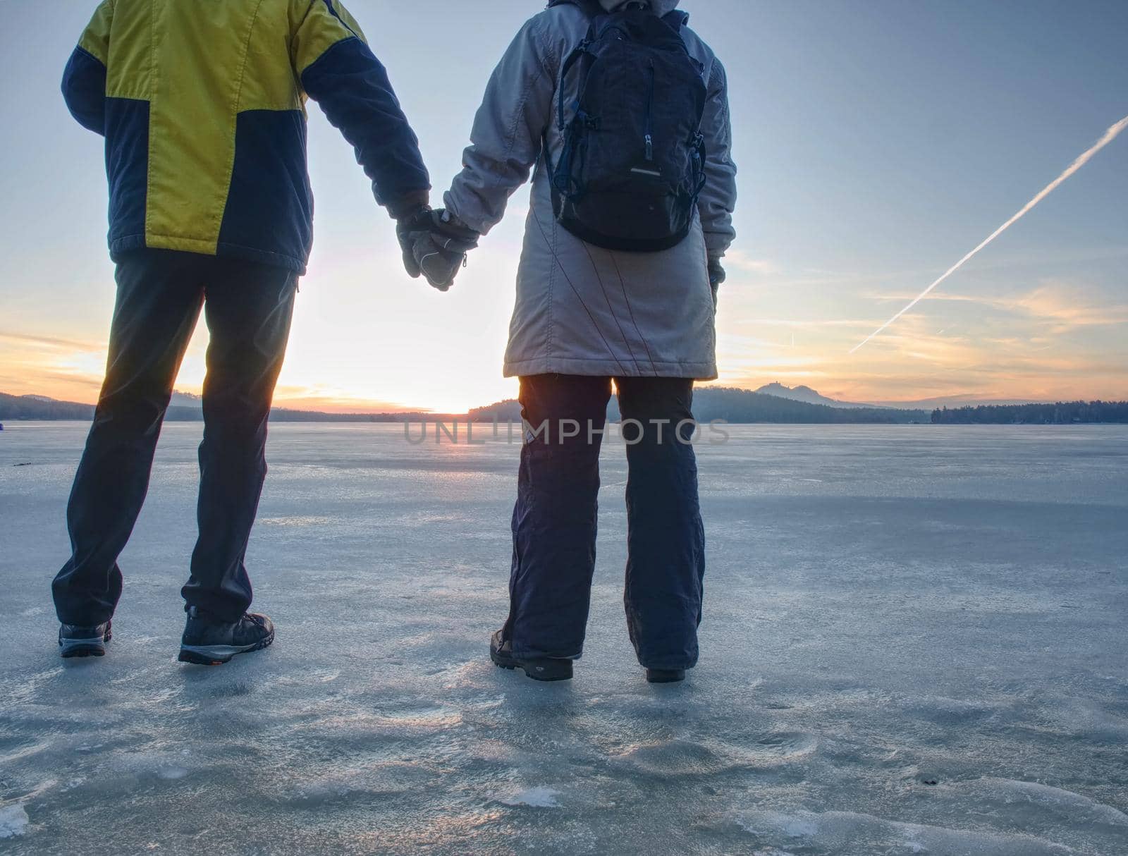 Pretty couple have fun on beach. Winter walk at frozen sea by rdonar2