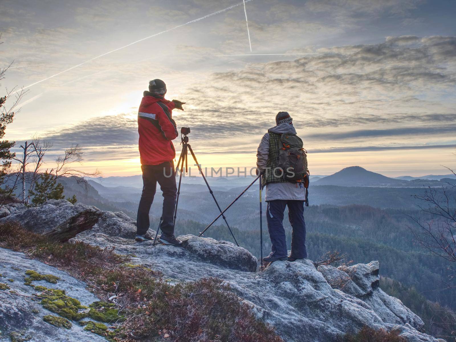 Nature photographers in red and light jacket take photo by rdonar2