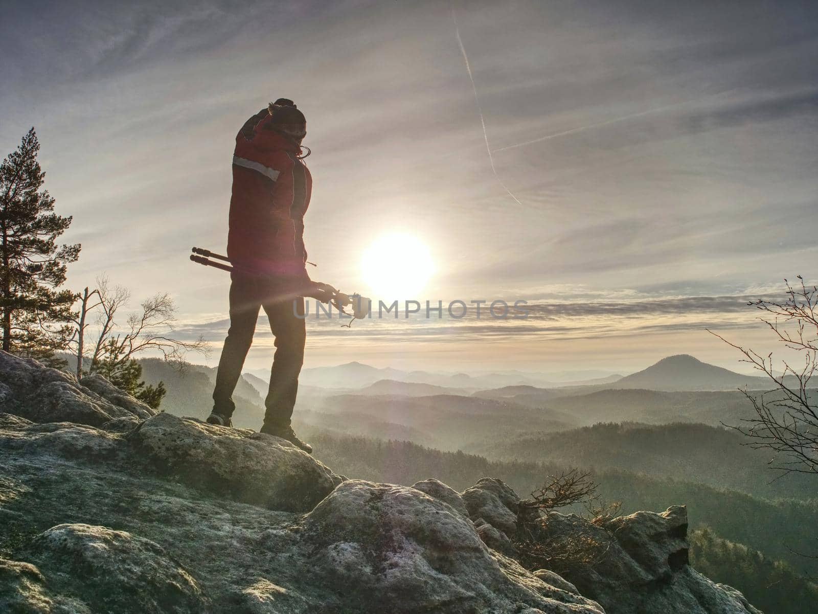 Two people stay at  tripod on background of a mountain range  by rdonar2